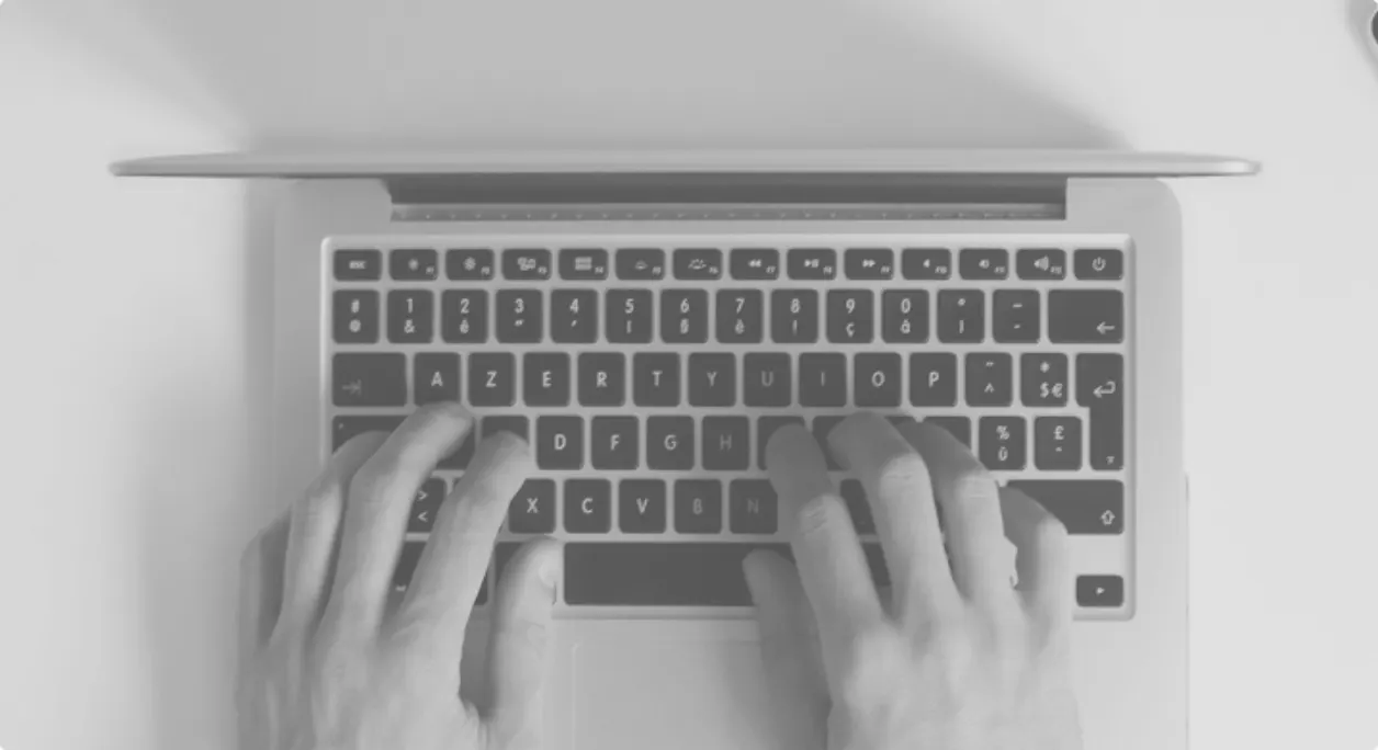Hands on a laptop keyboard